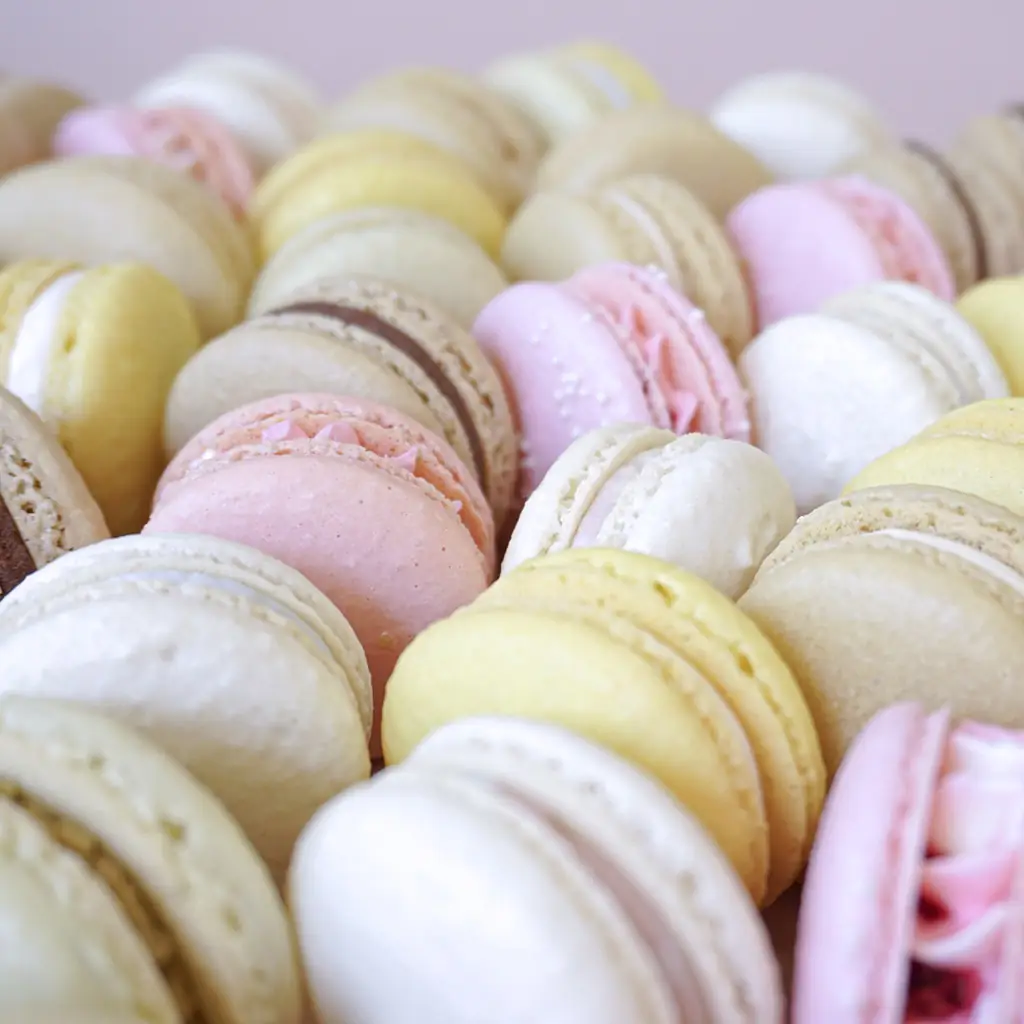 Close-up of macarons lined up in different colors, by Nadiya's Cupcakes