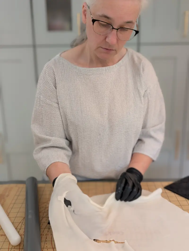 Nadiya holding and inspecting thinly stretched gum paste, by Nadiya's Cupcakes