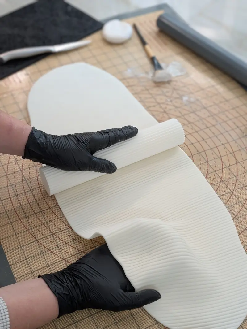 Nadiya rolling texture onto stretched gum paste, by Nadiya's Cupcakes